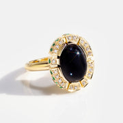 Regina diamond and green emerald halo ring with Australian black sapphire in 18ct yellow gold by Stefano Canturi